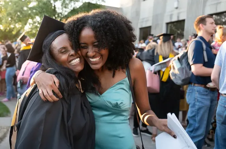 Hugging at graduation with Spanish and English students.